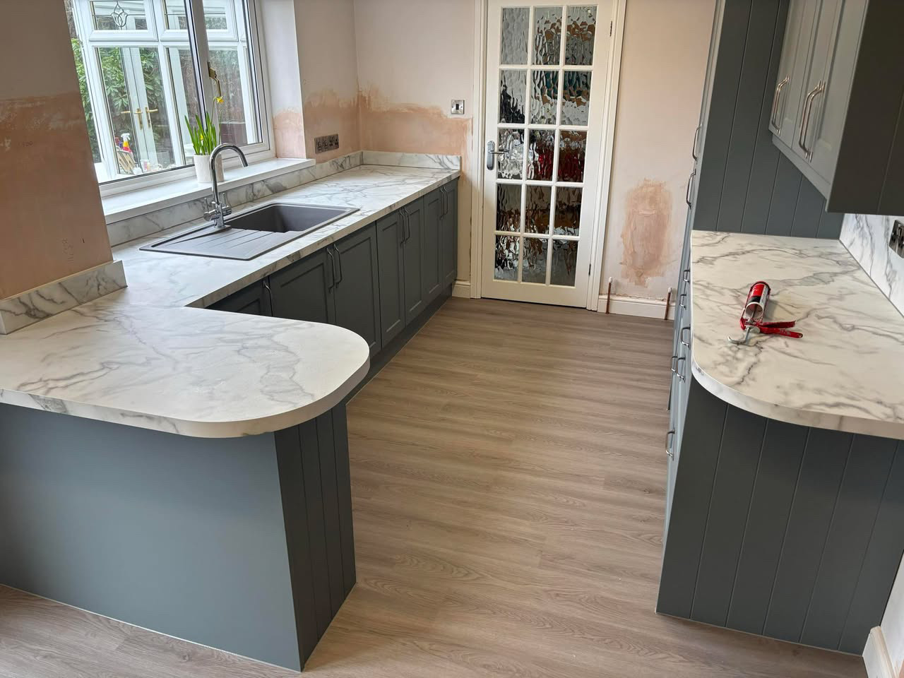 Sage kitchen with marble-effect breakfast bar (2)