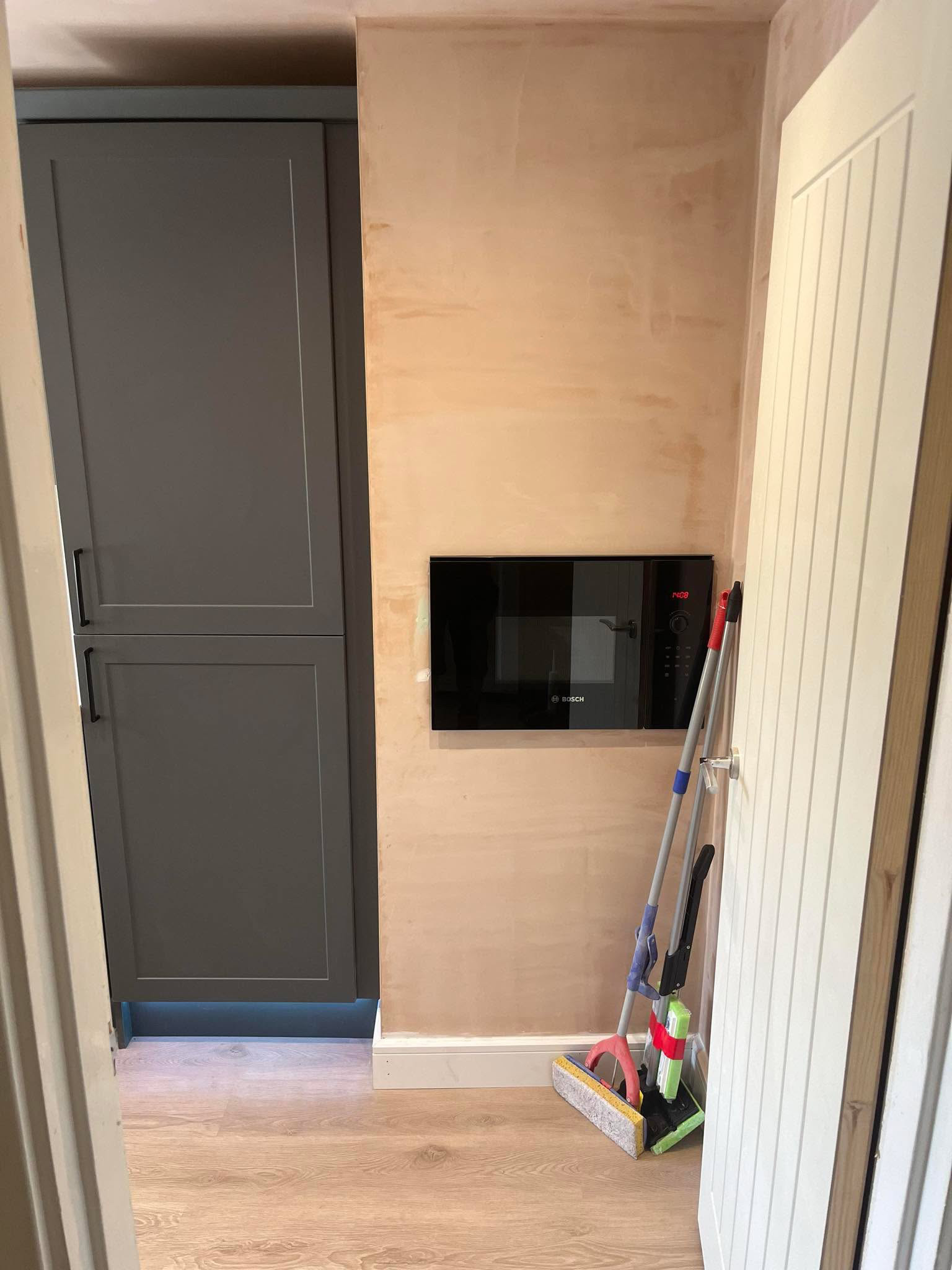 Grey shaker kitchen during finishing (2)